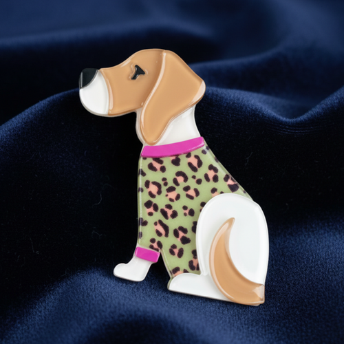 Acrylic beagle dog-shaped brooch wearing a leopard print outfit against a blue background