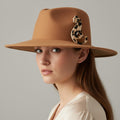 Cheetah print brooch pinned on a beige hat