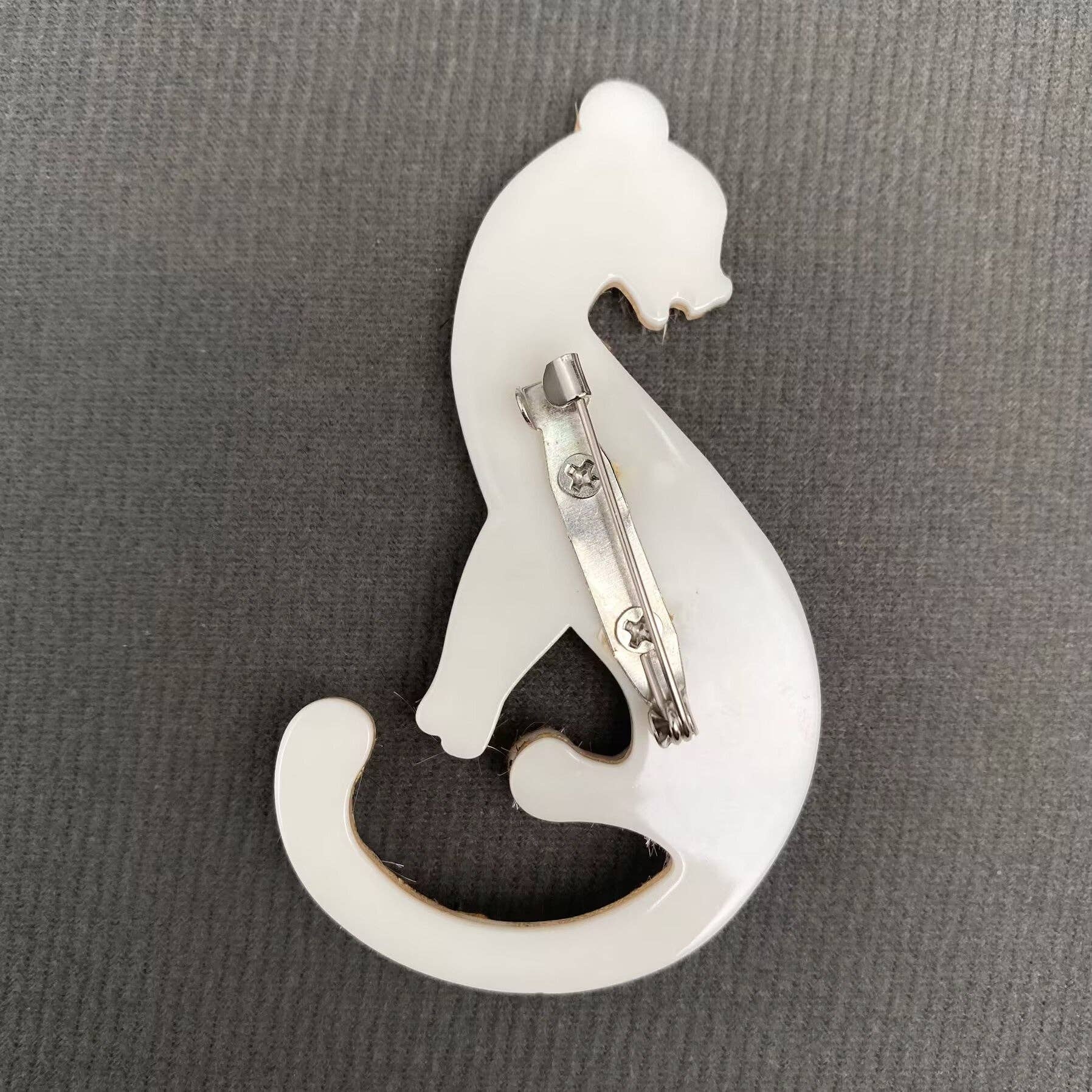 Back view of cheetah print brooch showing the clasp mechanism