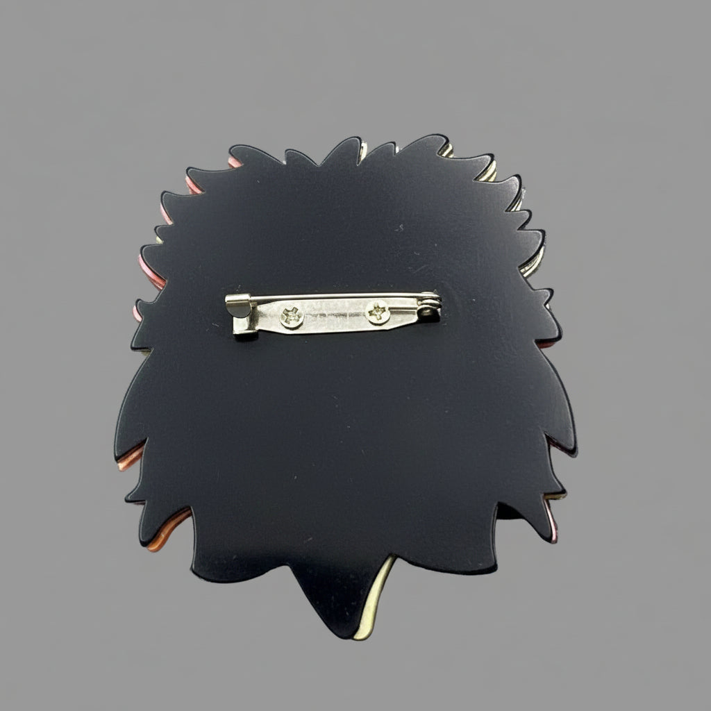 Back view of acrylic lion head brooch showing the clasp mechanism