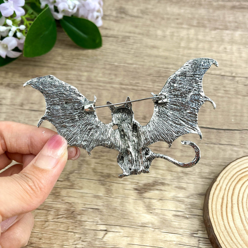 Back view of bat-shaped cat brooch showing the clasp and hinge mechanism