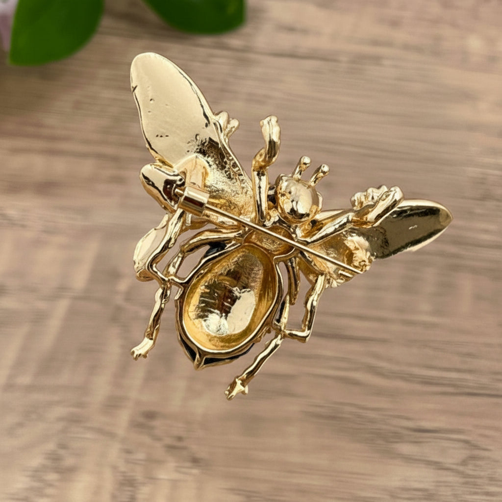 Back view of decorative bee brooch with floral details showing the clasp mechanism