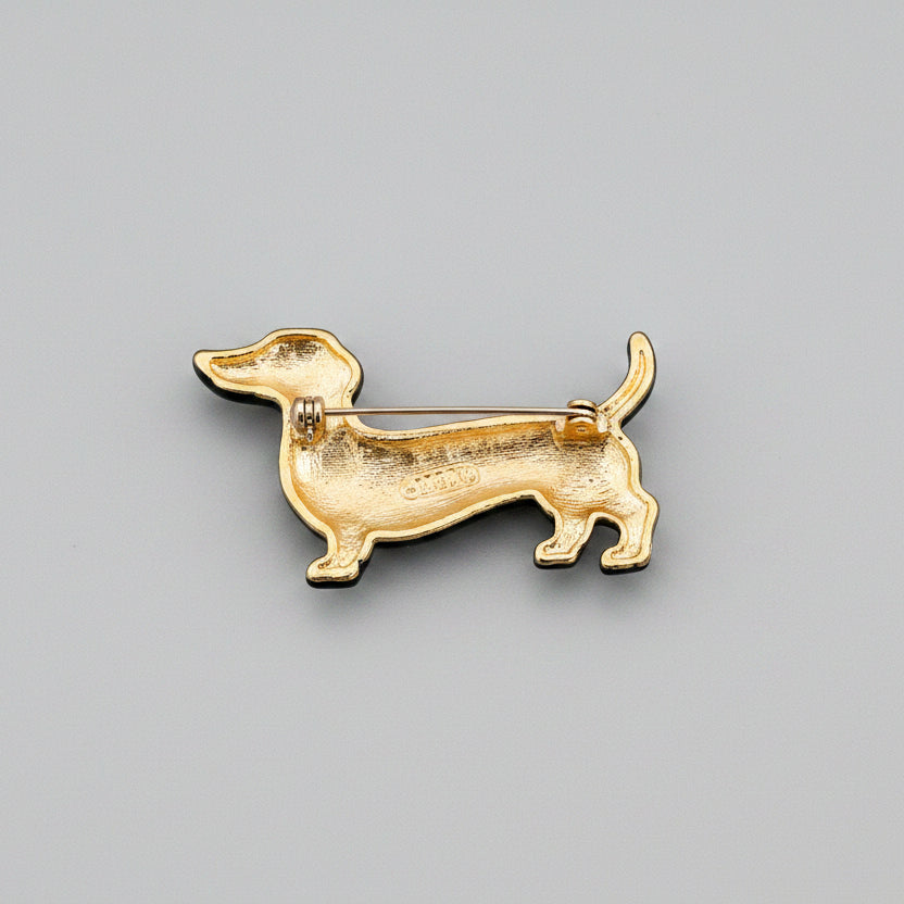 Back view of black and gold dachshund-shaped brooch showing the clasp mechanism