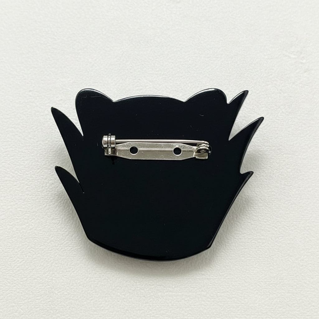 Back view of the acrylic black panther brooch showing the clasp mechanism