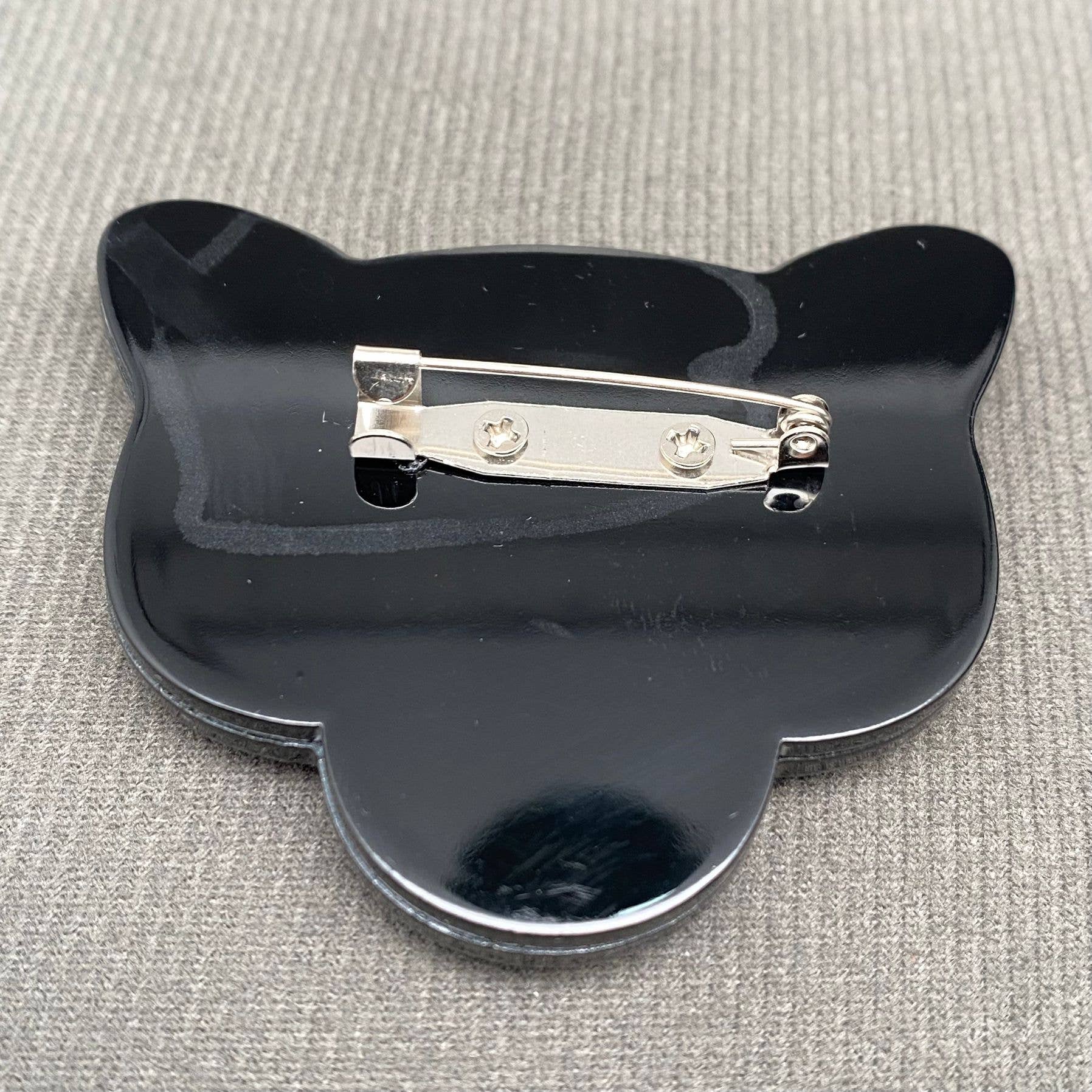 Back view of black panther head-shaped brooch showing the clasp mechanism