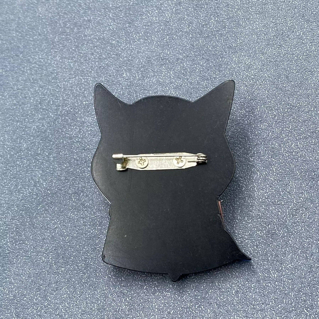 Back view of a cat-shaped brooch with a colorful design showing the clasp mechanism