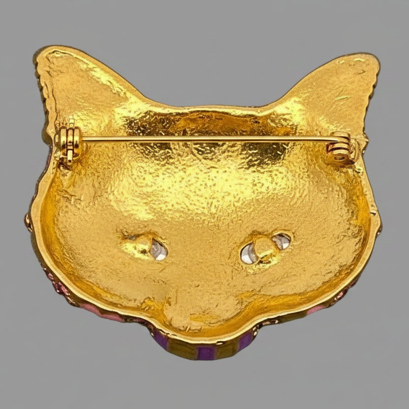 Back view of colorful cat-shaped mask brooch, showing the clasp mechanism