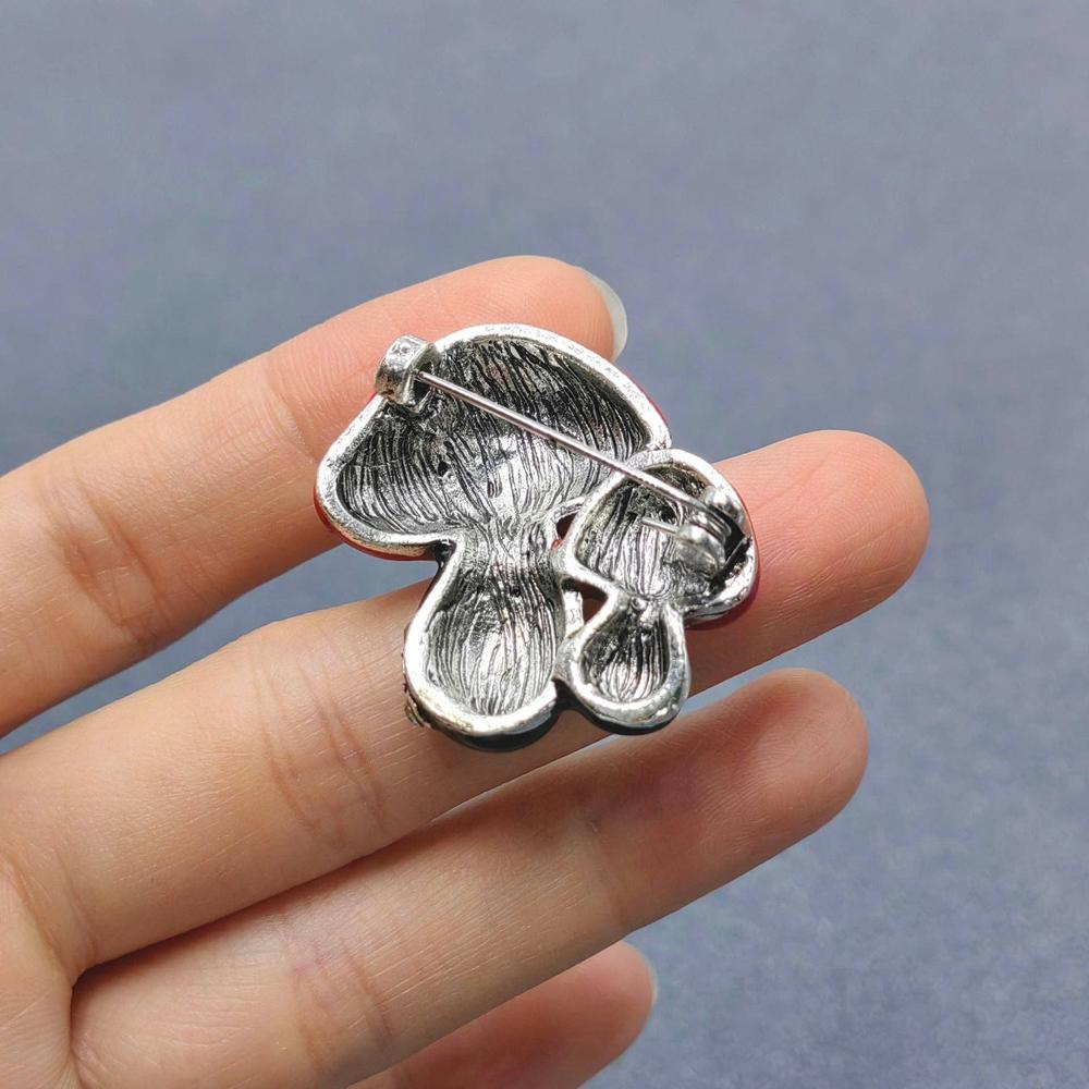 Back view of double mushroom brooch showing clasp and hinge mechanism