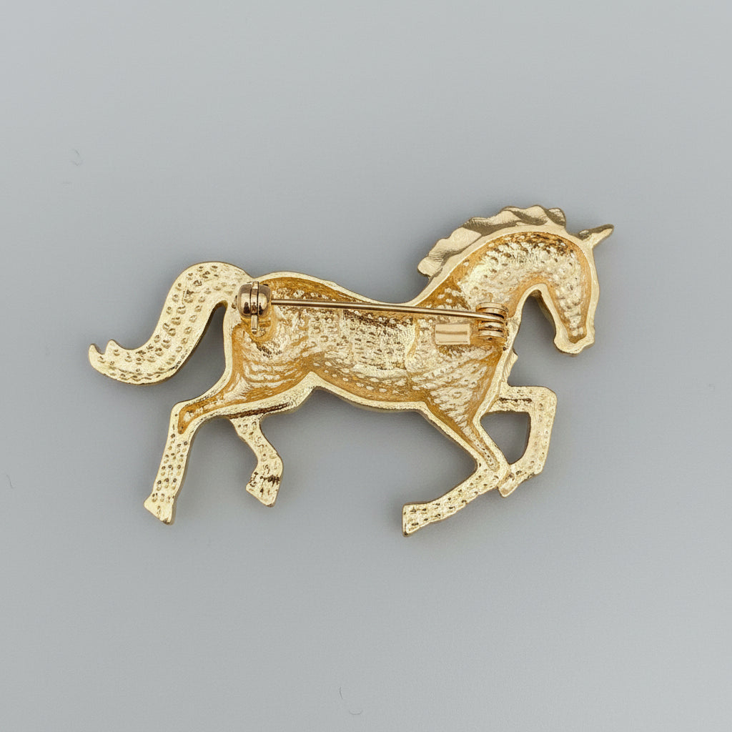 Back view of a horse-shaped brooch showing the clasp mechanism on a gray background