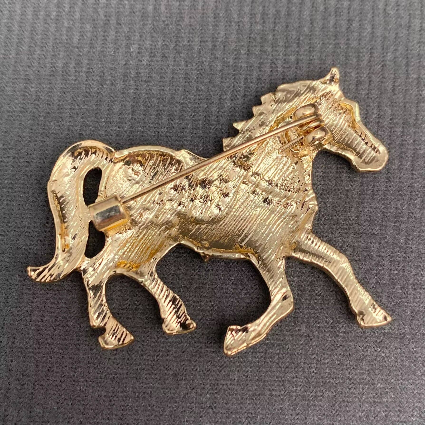 Back view of horse-shaped brooch, showing the clasp mechanism