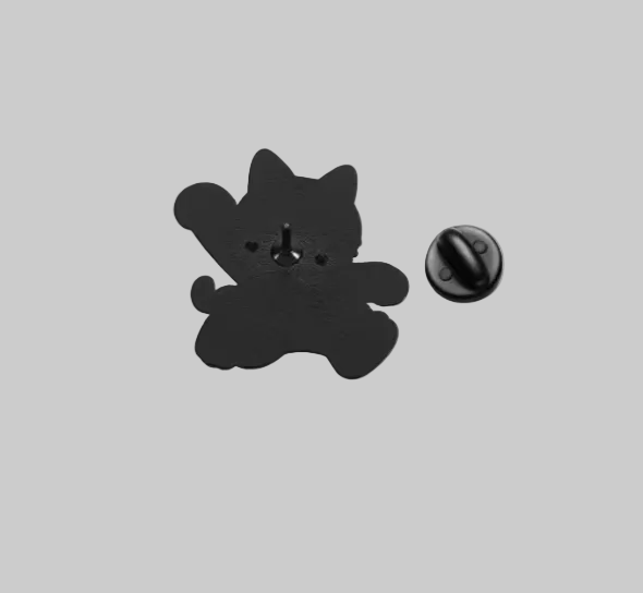 Back view of black and white cat-shaped lapel pin, showing the pin closure