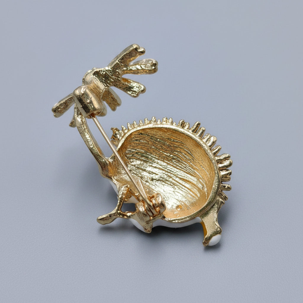 Back view of hedgehog brooch holding a flower, showing clasp mechanism on a gray background