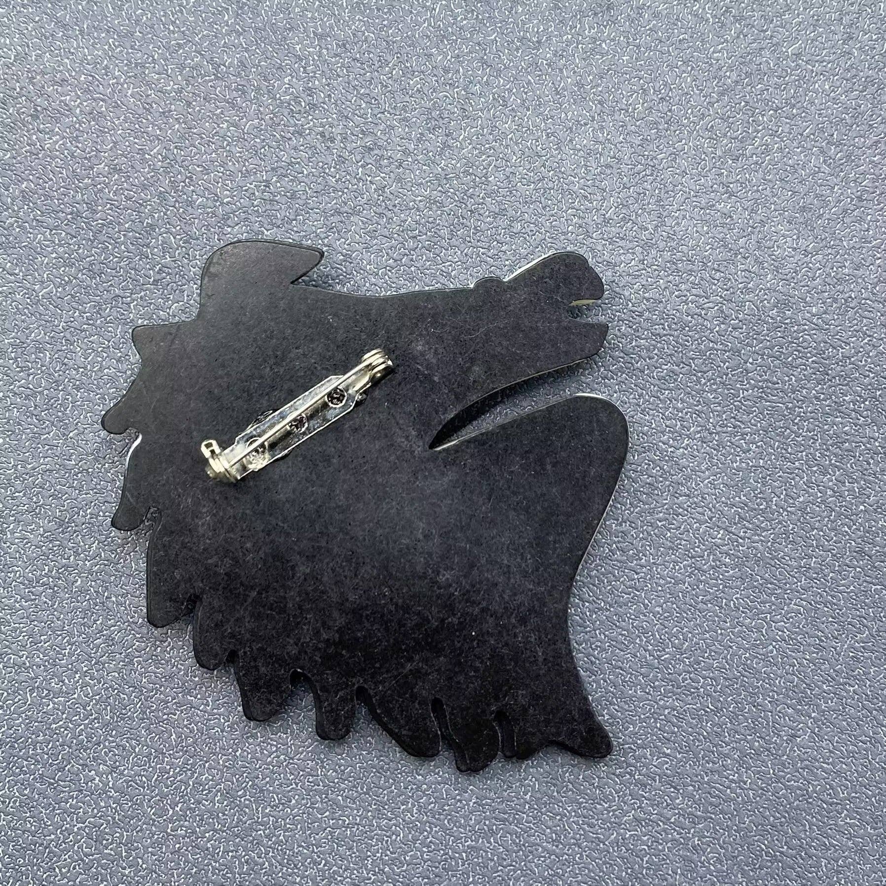 Back view of acrylic horse head brooch showing clasp mechanism