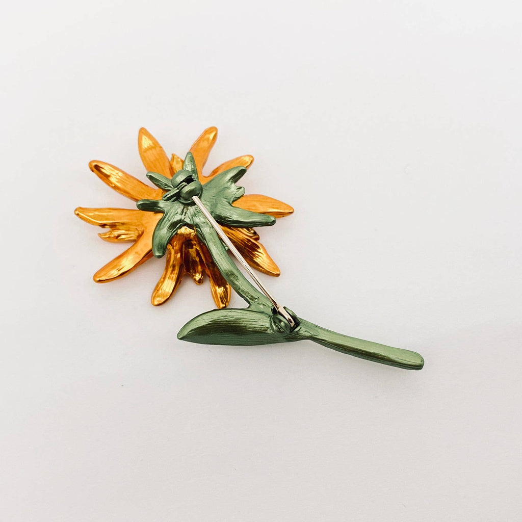 Back view of gold sunflower-shaped brooch, showing the clasp mechanism