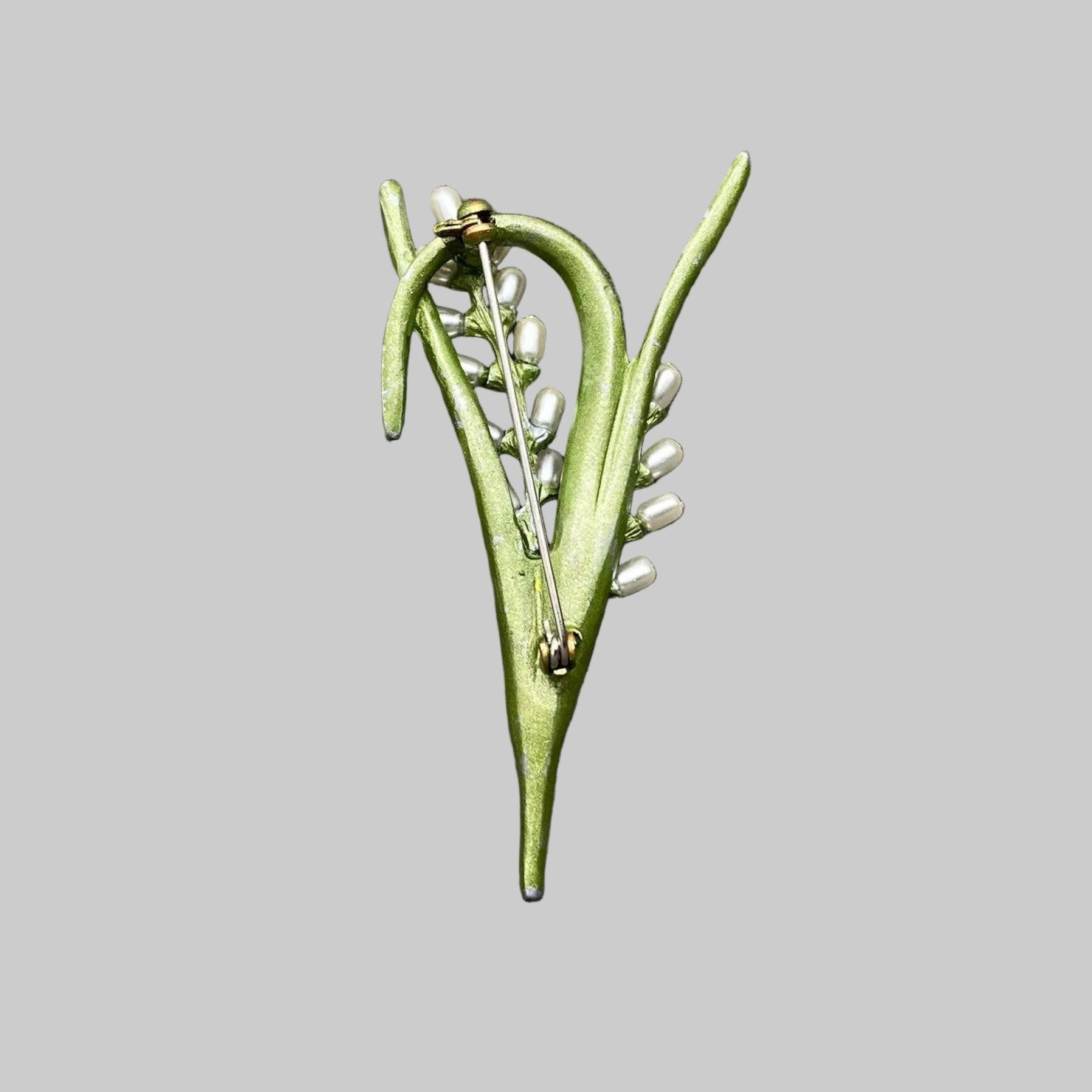 Back view of green enamel rice plant brooch with pearl accents, showing the clasp mechanism