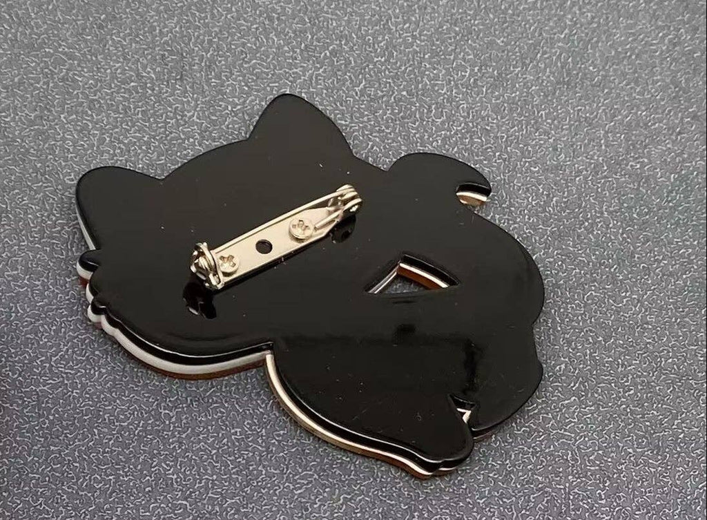 Back view of acrylic cat-shaped brooch showing clasp mechanism