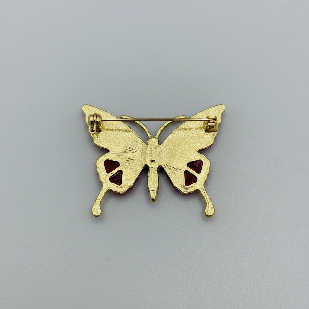 Back view of butterfly-shaped brooch with gemstones, showing the clasp mechanism 