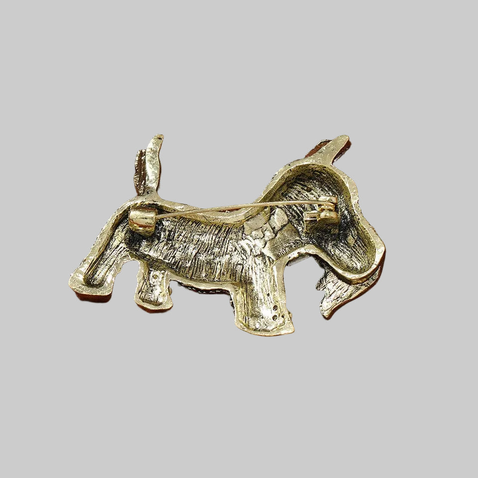Back view of decorative dog-shaped brooch showing the clasp mechanism