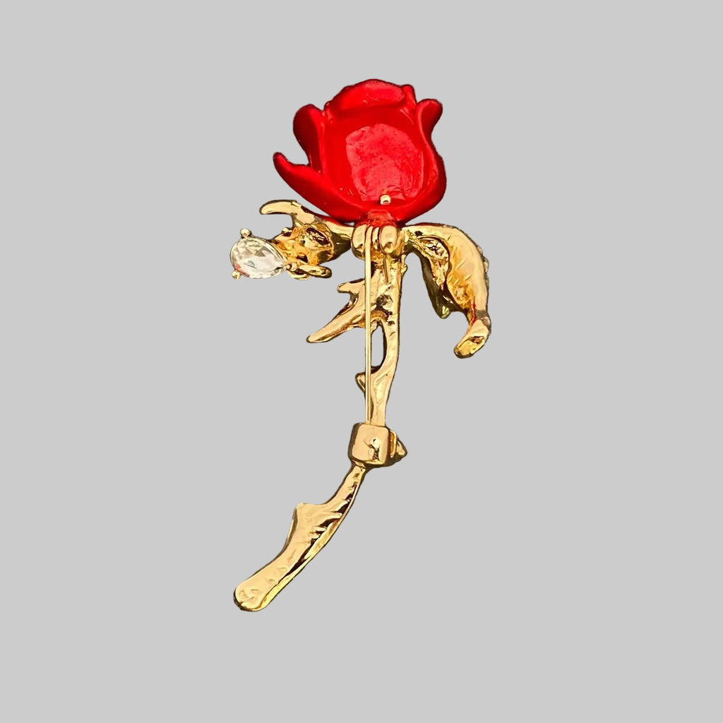 Back view of red rose brooch with gold leaves, showing the clasp mechanism