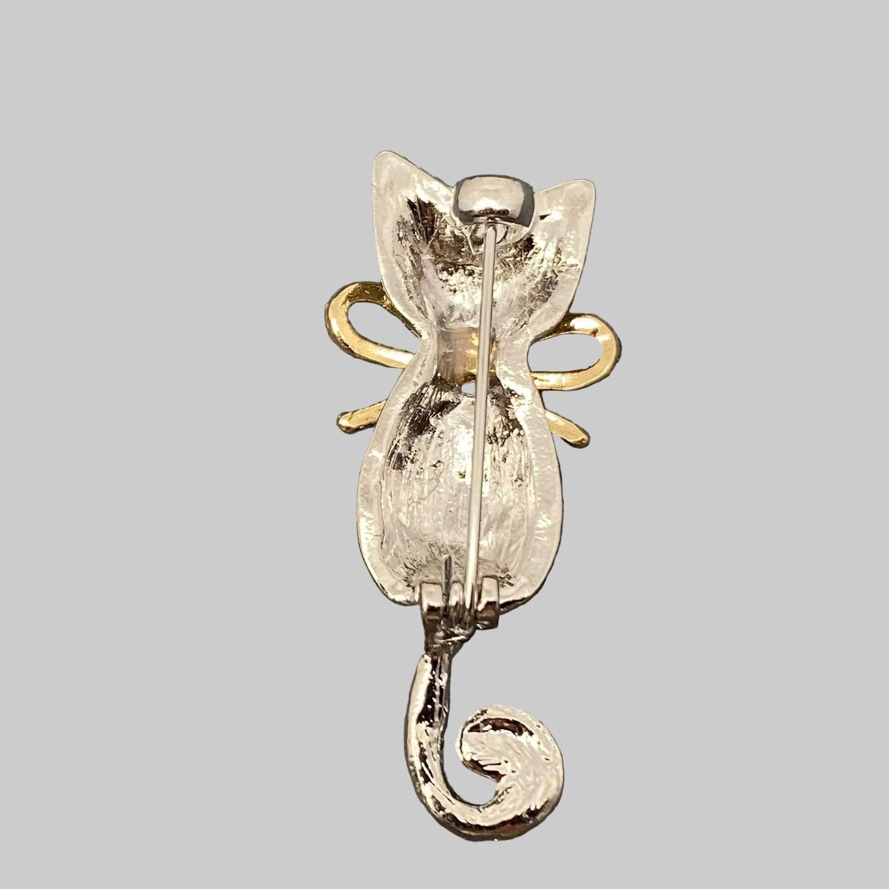 Back view of cat-shaped brooch with rhinestones, showing the clasp mechanism