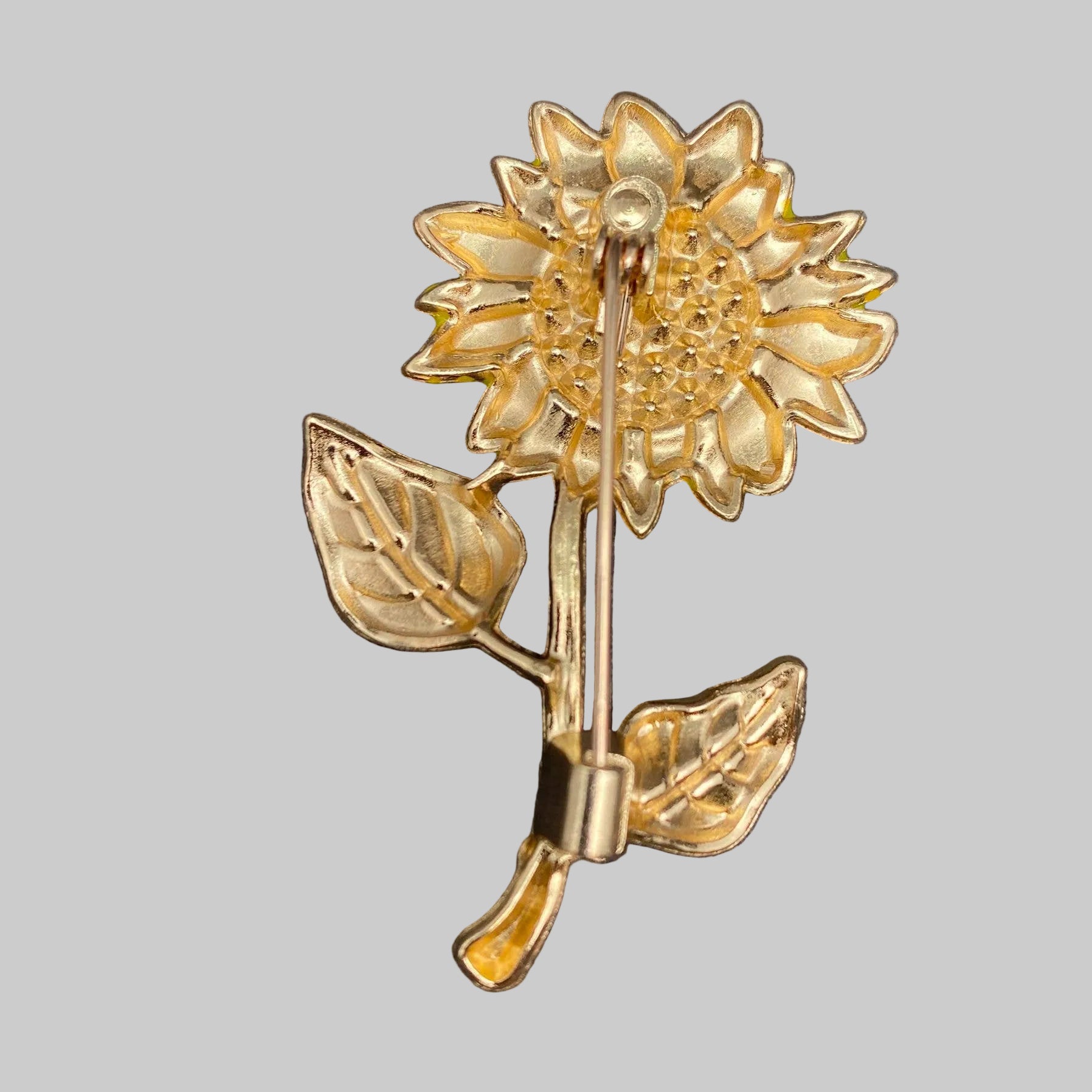 Back view of sunflower-shaped brooch, showing the clasp mechanism