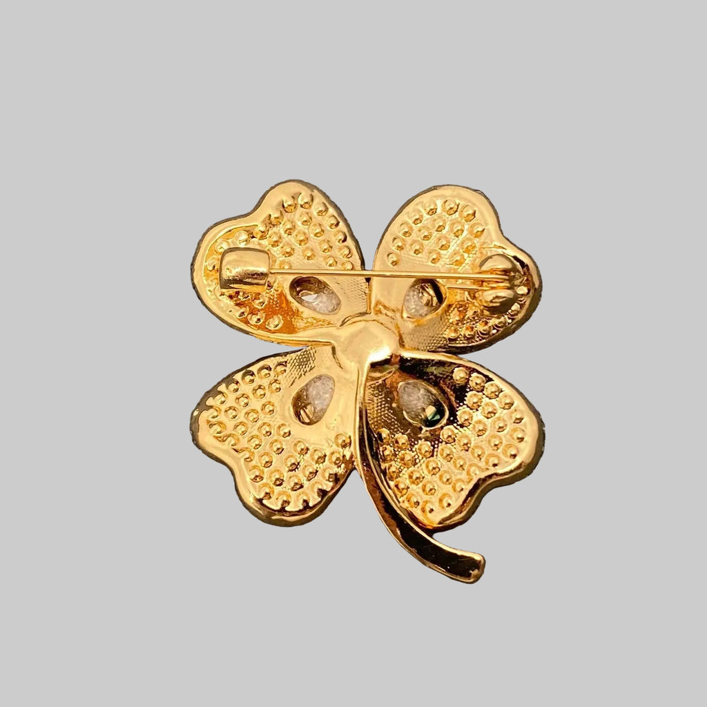 Back view of green four-leaf clover brooch with gold accents, showing the clasp mechanism