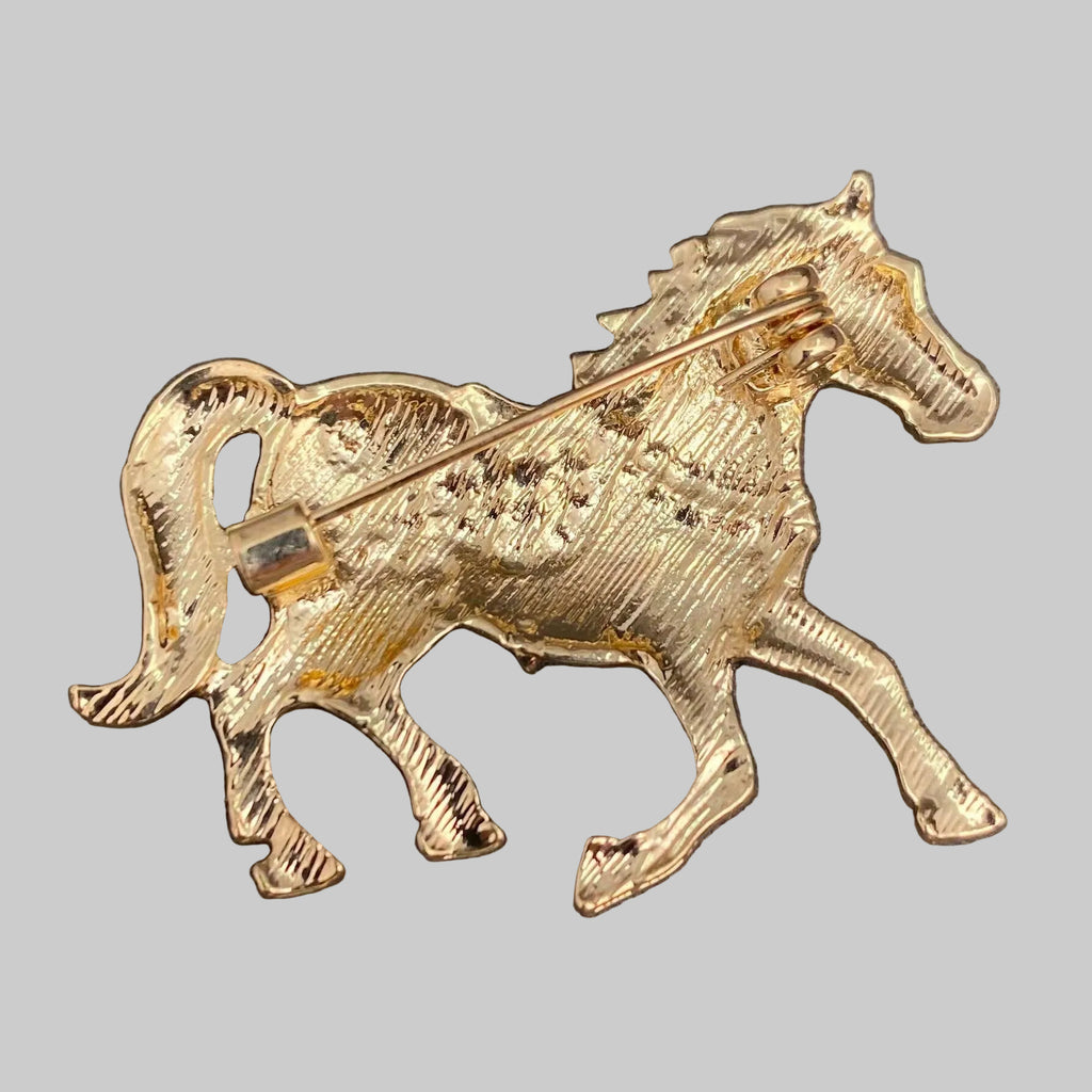 Back view of horse brooch, showing the clasp mechanism, against a gray background.