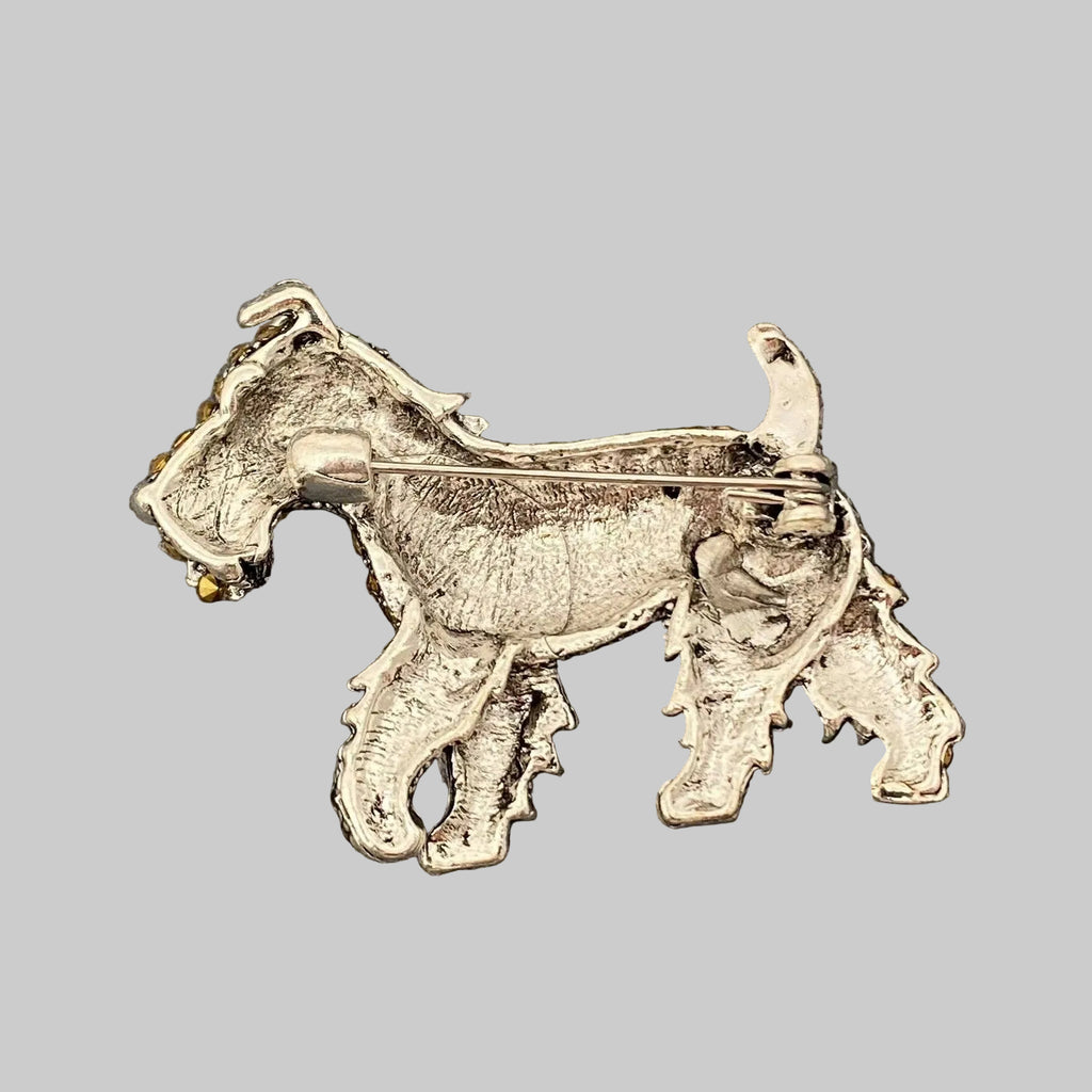 Back view of dog-shaped brooch with yellow and red stones, showing the clasp mechansim