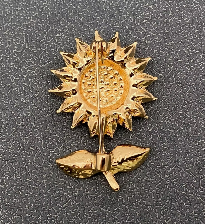 Back view of rhinestone sunflower brooch pin, showing the clasp mechanism