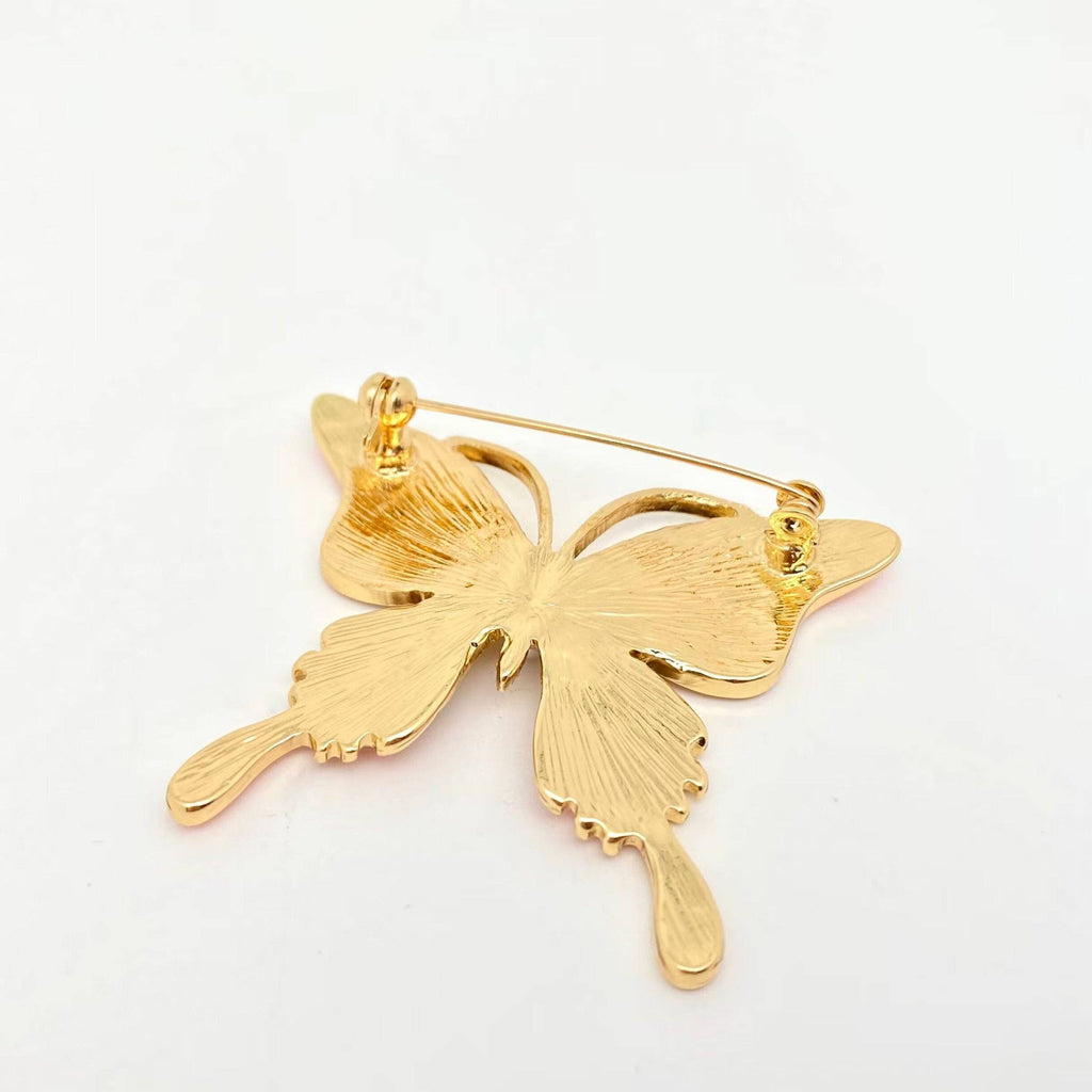 Back view of colorful butterfly-shaped brooch showing clasp mechanism