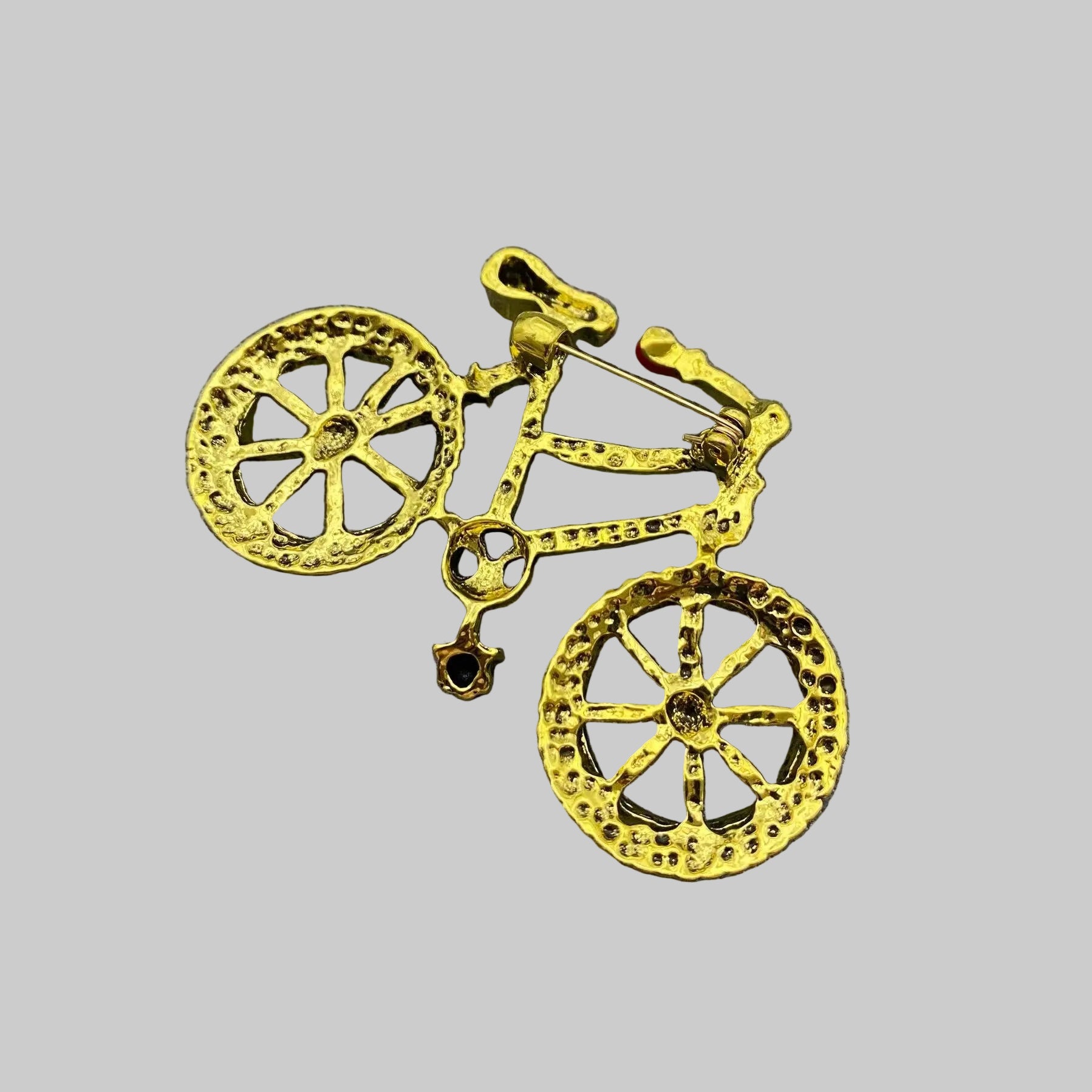 Back view of bicycle shaped brooch showing the clasp mechanism
