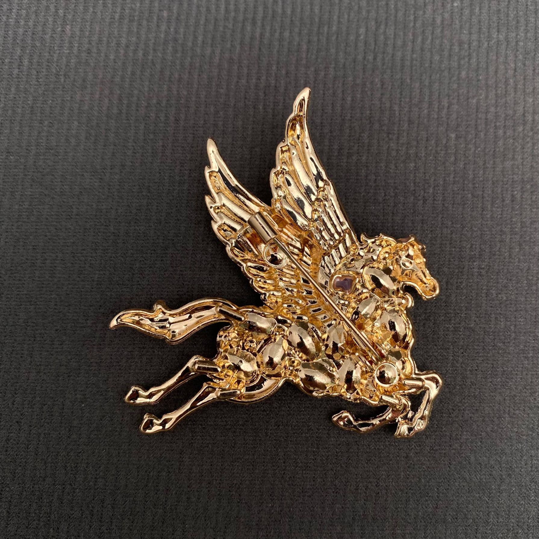 Back view of pegasus brooch showing the clasp mechanism