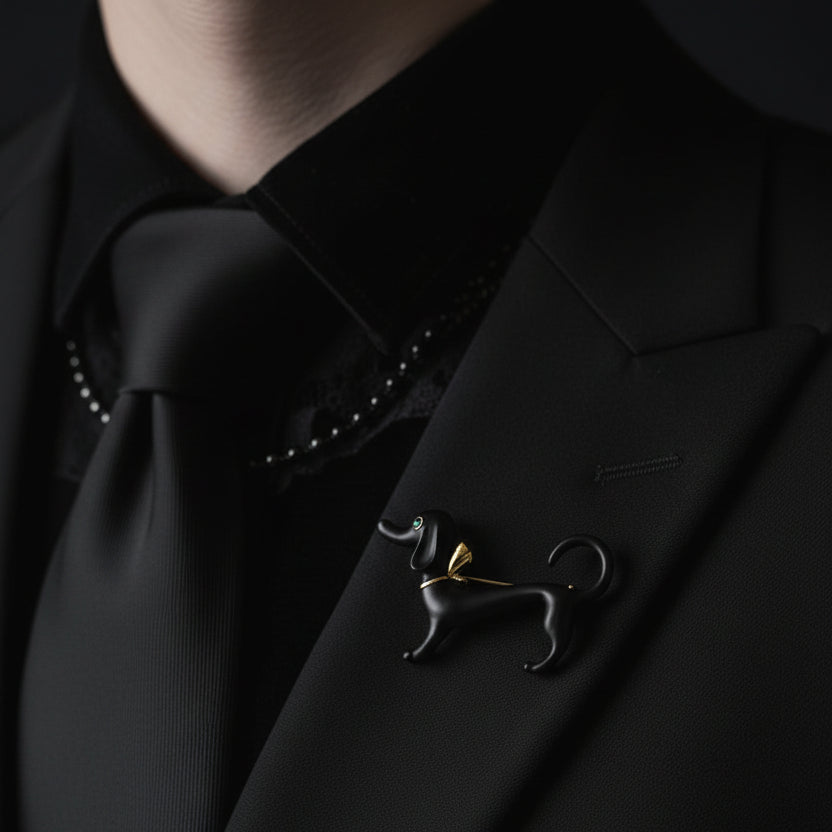 Black and gold dachshund-shaped brooch pinned on a black suite
