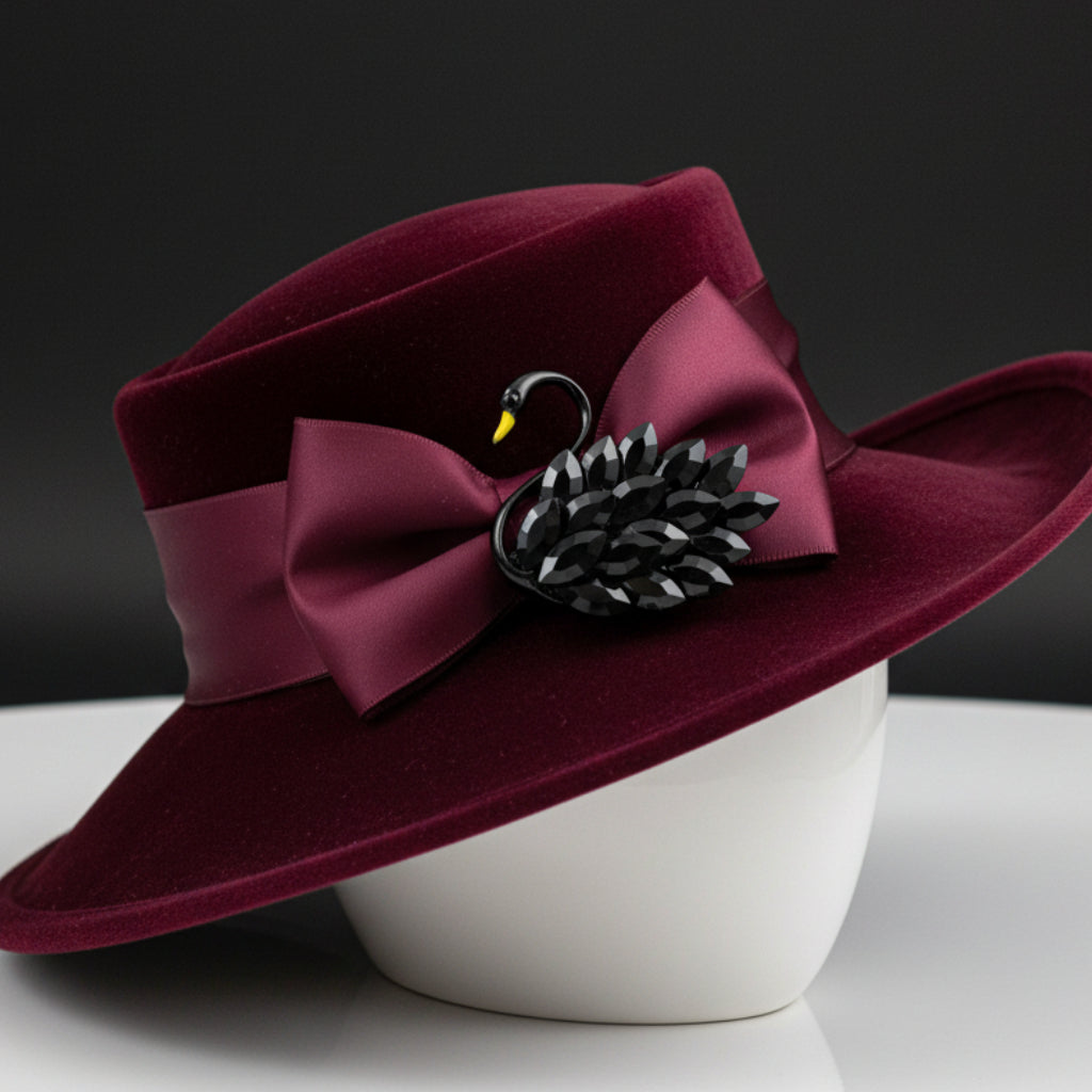 Black swan-shaped brooch pinned on a red velvet hat