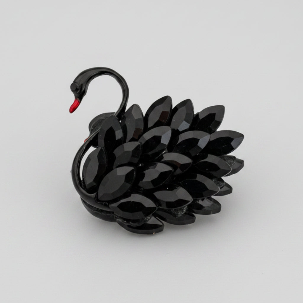 Black swan-shaped brooch on a gray  background