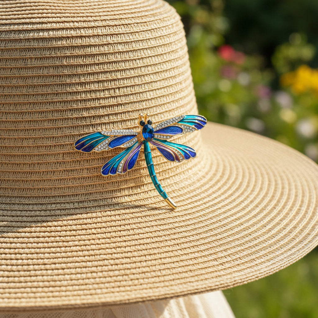 Colorful dragonfly-shaped brooch pinned on a straw hat