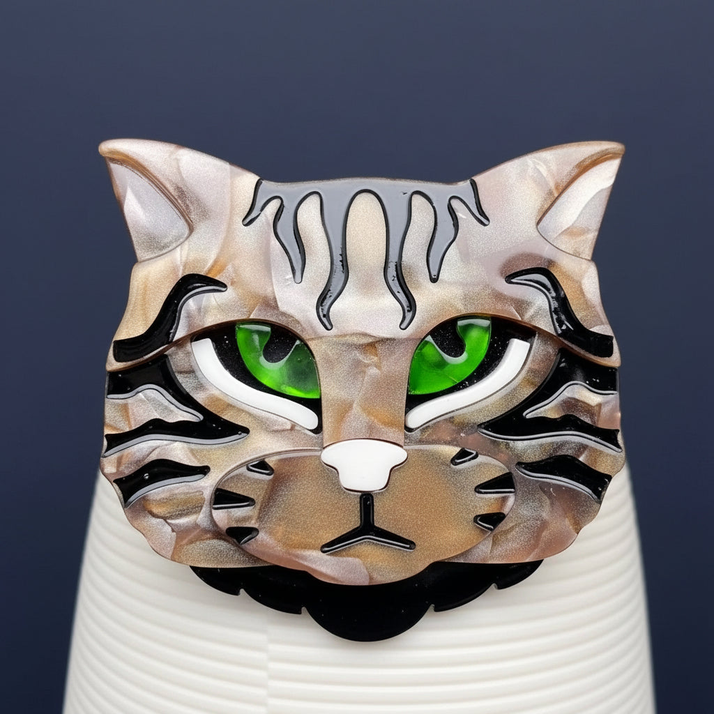 Acrylic cat-shaped brooch with green eyes on a gray background
