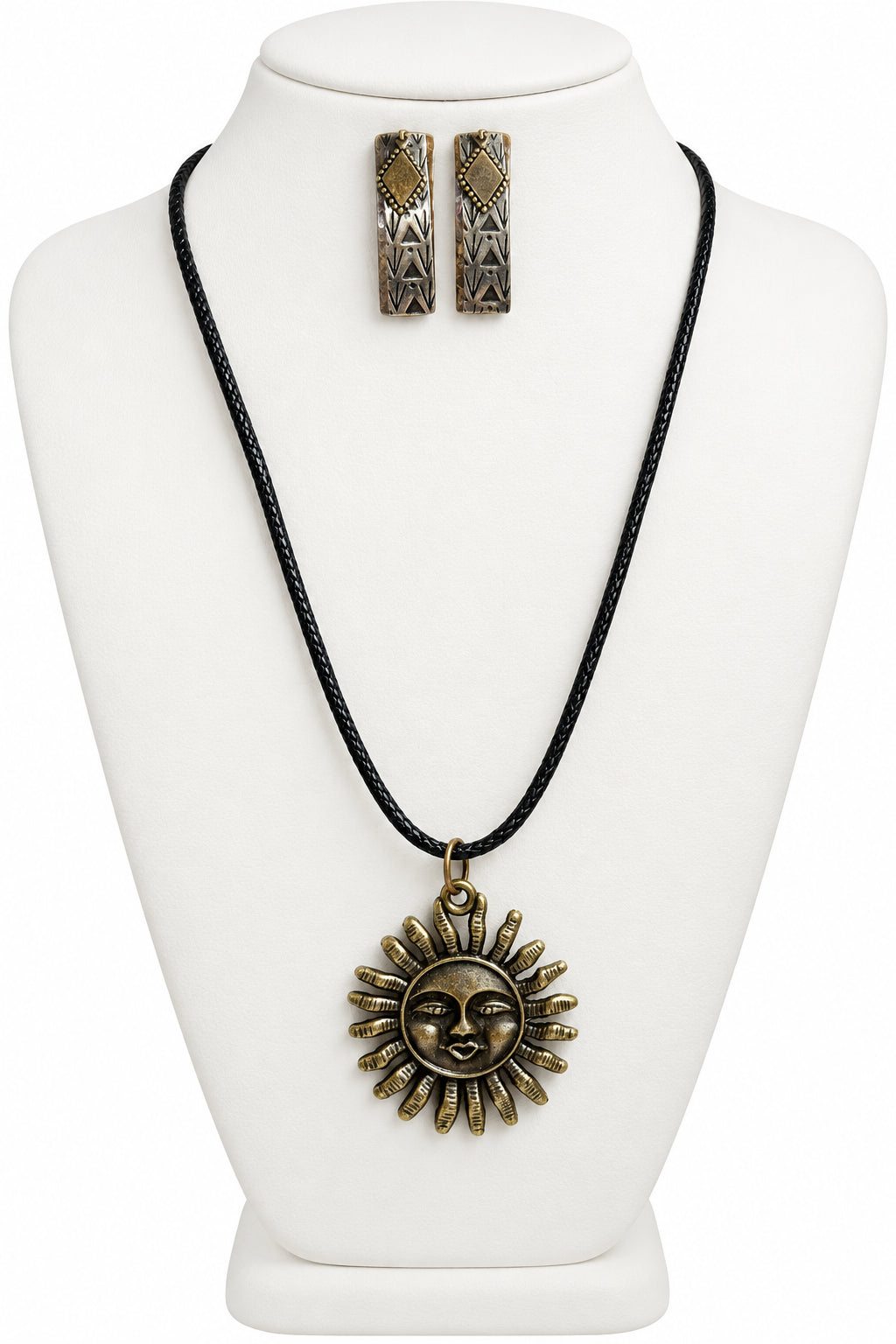 A black cord necklace with an antique bronze sun pendant, displayed on a cream-colored bust alongside matching mix-metal earrings.