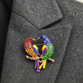 Colorful bird-shaped brooch on a gray background