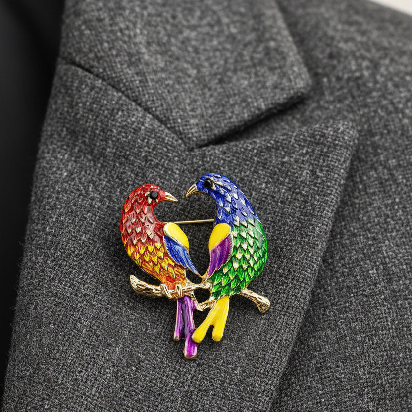 Colorful bird-shaped brooch on a gray background