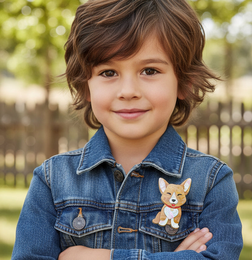 Dog-shaped brooch with a red collar pinned on a boy's denim jacket 