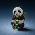Panda-shaped brooch with gemstones on a dark blue background