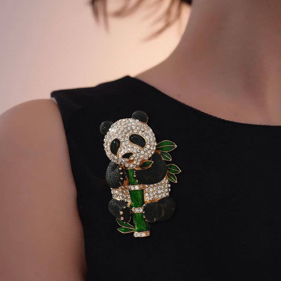 Panda-shaped brooch with gemstones pinned on a black dress