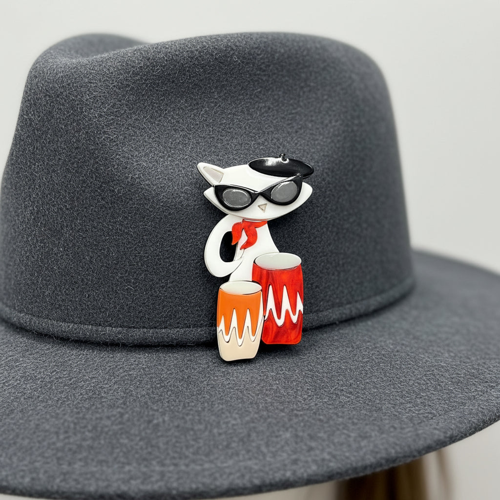 Acrylic cat-shaped brooch with sunglasses and drums on a gray background