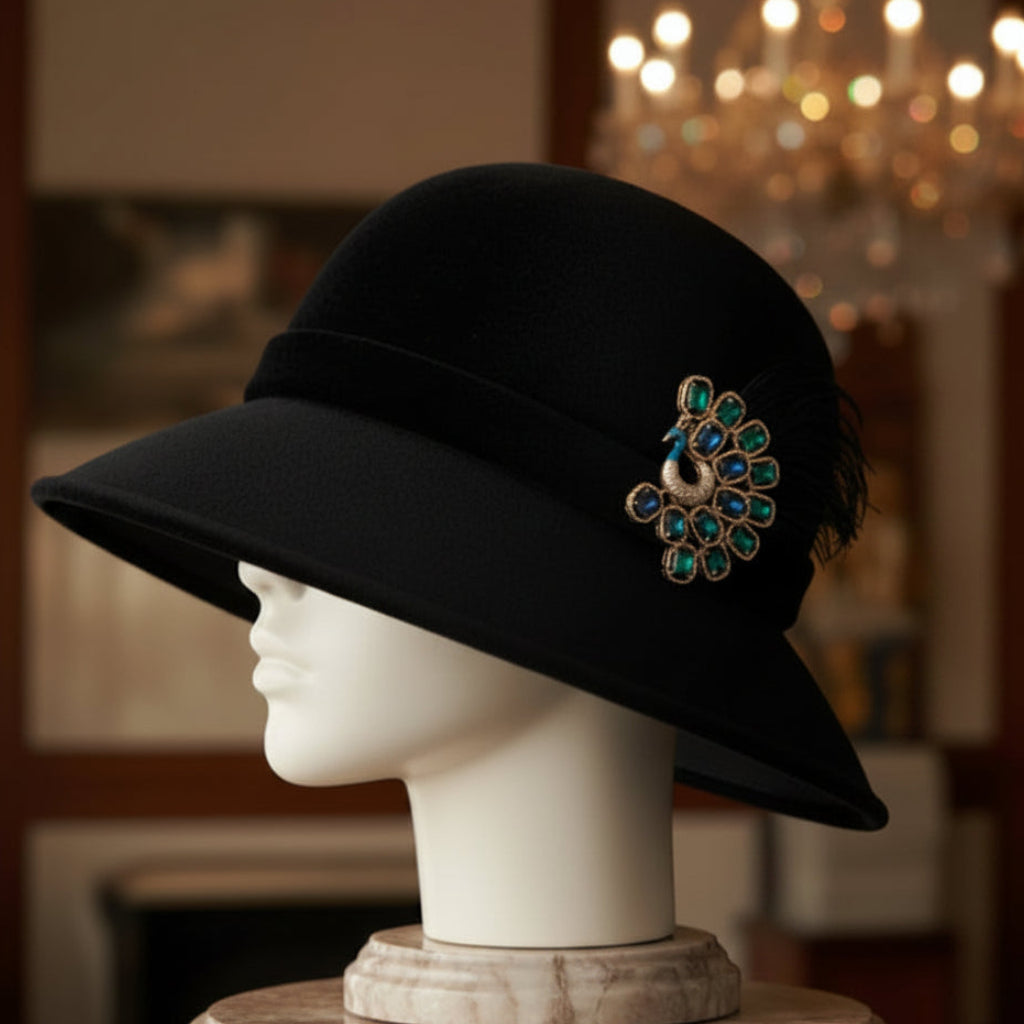 Peacock-shaped brooch with green and blue gemstones, pinned on a black velvet hat