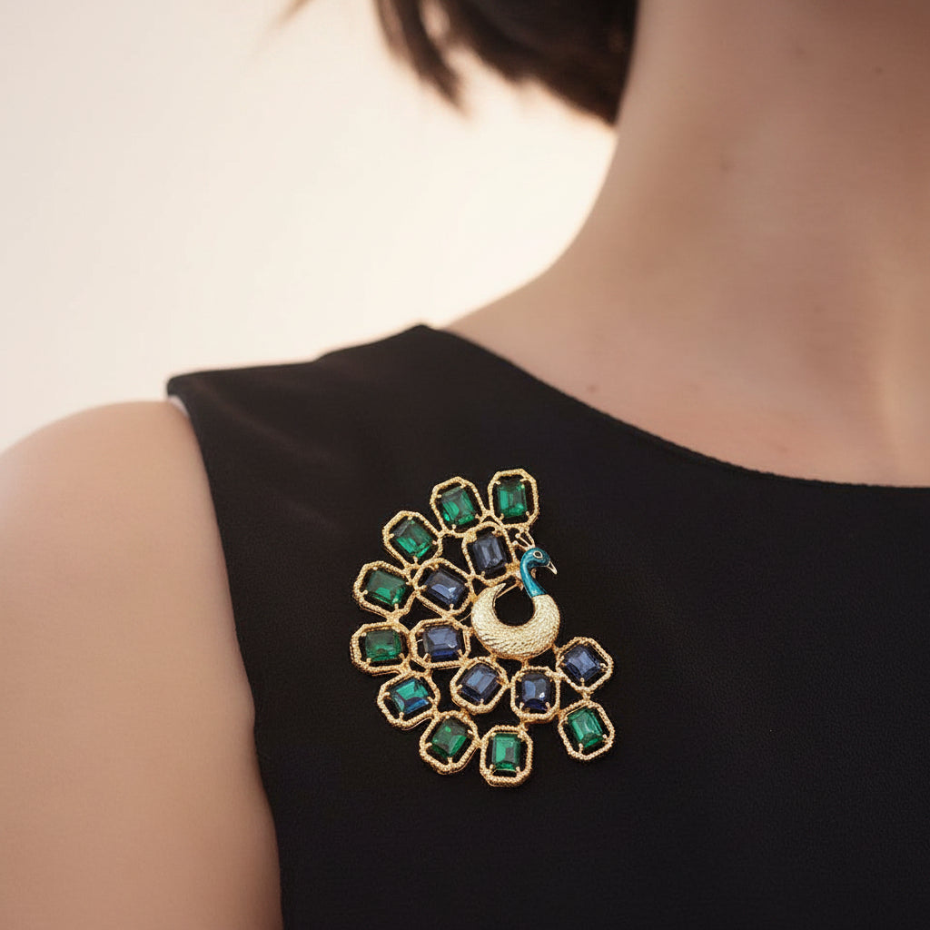 Peacock-shaped brooch with green and blue gemstones, pinned on a woman's black dress
