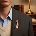 Decorative pin of a musician playing a cello pinned on a man's suit