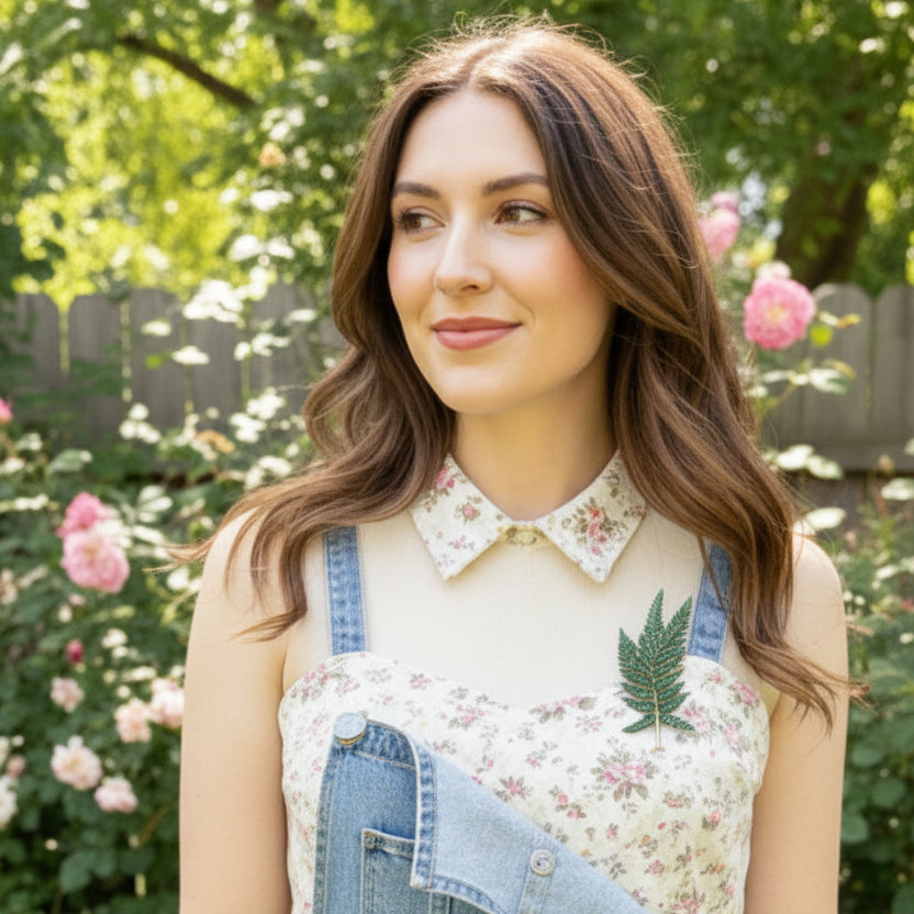 Fern leaf shape plant brooch pinned on a floral and denim romper