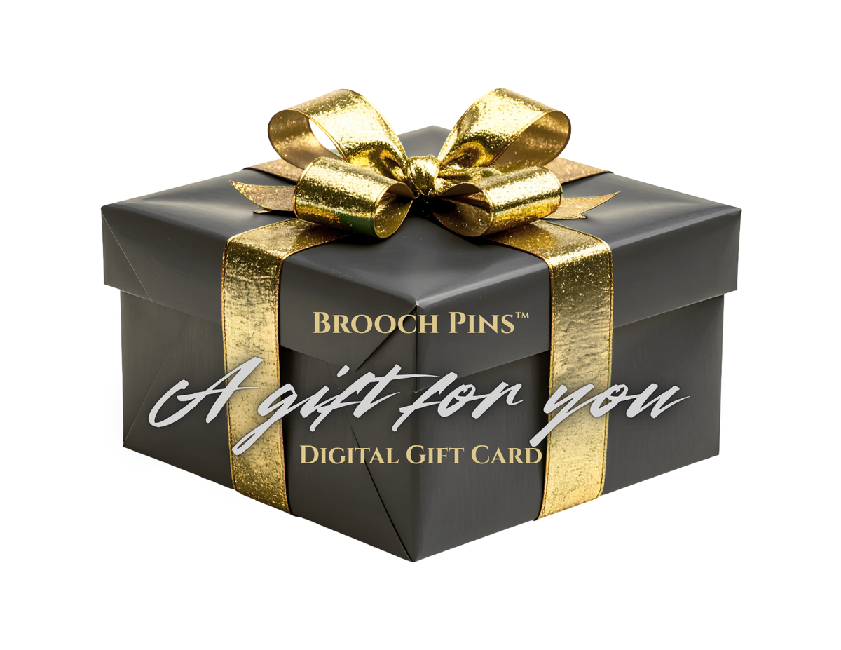 A black gift box wrapped with a metallic gold ribbon and bow, featuring the text 'BROOCH PINS' and 'A gift for you DIGITAL GIFT CARD' on a white background.