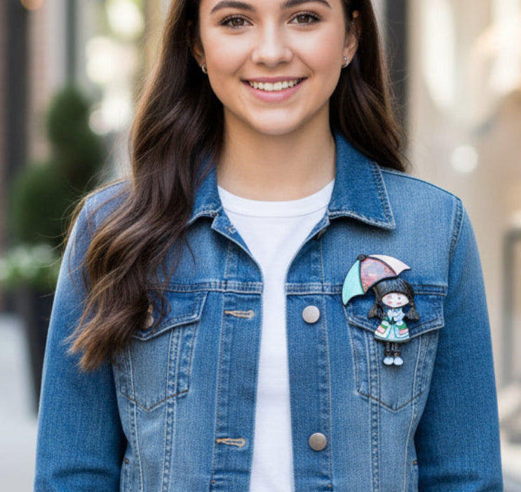 Colorful brooch of a girl with an umbrella, pinned on a denim jacket